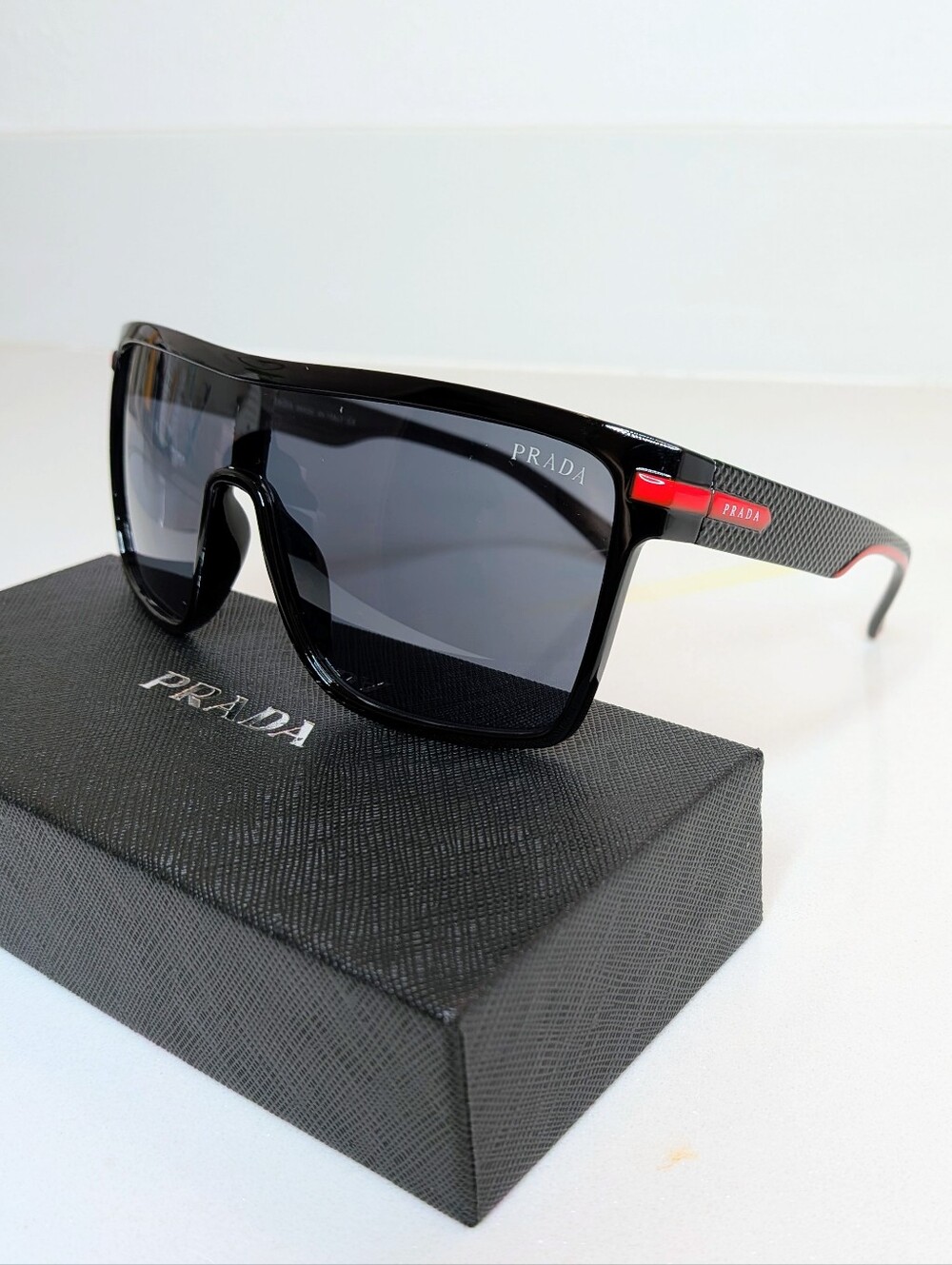 Prada Men's Black Shield Sunglasses Red Logo